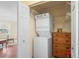 A compact laundry area features a stackable washer and dryer next to a chest of drawers at 6702 Dartmoor Ln # 7A, New Port Richey, FL 34653