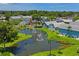 Scenic pond with fountains surrounded by manicured lawns and charming residential buildings in a tranquil community setting at 6702 Dartmoor Ln # 7A, New Port Richey, FL 34653