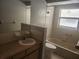 Well-lit bathroom featuring a toilet, a sink, and a tub at 7338 Foxbloom Dr, Port Richey, FL 34668