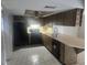 Well-lit kitchen featuring ample counter space, wood cabinetry, and modern black appliances at 7338 Foxbloom Dr, Port Richey, FL 34668
