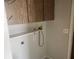 Laundry area with overhead cabinets and plumbing connections for washer and dryer at 7338 Foxbloom Dr, Port Richey, FL 34668