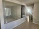 Bright living room featuring a large mirror accent wall and neutral paint colors at 7338 Foxbloom Dr, Port Richey, FL 34668