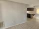 Open living space with tile flooring flowing into a kitchen area with modern cabinetry at 7338 Foxbloom Dr, Port Richey, FL 34668