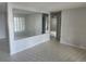 Bright living room with large mirror, tile flooring, and a view into other rooms at 7338 Foxbloom Dr, Port Richey, FL 34668