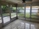 View of screened patio featuring tiled floor and view of the backyard, great for outdoor enjoyment at 7338 Foxbloom Dr, Port Richey, FL 34668