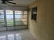Enclosed patio with tile flooring, offering a versatile space for relaxation and entertainment at 7338 Foxbloom Dr, Port Richey, FL 34668