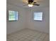 Bright, minimalist bedroom with tiled floor and two windows at 8504 Lafitte Dr, Hudson, FL 34667