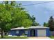 Charming blue one-story home featuring an attached garage and arched entry at 8504 Lafitte Dr, Hudson, FL 34667