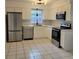 Modern kitchen featuring stainless steel appliances and white cabinetry at 8504 Lafitte Dr, Hudson, FL 34667
