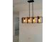Stylish light fixture over looking an airy room with tiled floors at 8504 Lafitte Dr, Hudson, FL 34667