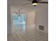 Bright living room with tile flooring, modern light fixtures, and an open layout at 8504 Lafitte Dr, Hudson, FL 34667