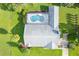 Aerial view of screened in pool, roof, backyard, and verdant lawn at 8522 Cranes Roost Dr, New Port Richey, FL 34654