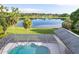 Screened pool with views of serene pond and neighboring homes at 8522 Cranes Roost Dr, New Port Richey, FL 34654