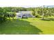 Expansive backyard with a screened pool, lush lawn, and various trees at 8522 Cranes Roost Dr, New Port Richey, FL 34654