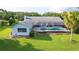 Backyard with screened pool, meticulously landscaped garden beds, and well-kept lawn at 8522 Cranes Roost Dr, New Port Richey, FL 34654