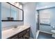 Modern bathroom with sleek vanity, mirror, and glass-enclosed shower, offering a spa-like retreat at 8522 Cranes Roost Dr, New Port Richey, FL 34654