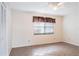 Clean and well-lit bedroom, featuring tiled floors and a window, bathed in natural light at 8522 Cranes Roost Dr, New Port Richey, FL 34654