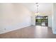 Bright dining area with tile floors, chandelier, and a sliding glass door at 8522 Cranes Roost Dr, New Port Richey, FL 34654