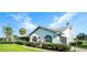 Charming home exterior with arched windows and a well-maintained green lawn at 8522 Cranes Roost Dr, New Port Richey, FL 34654