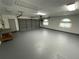 Spacious garage with an automatic door, utility door and unique stained glass windows at 8522 Cranes Roost Dr, New Port Richey, FL 34654