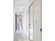 Bright hallway featuring geometric tiled floors, leading to various rooms in the house at 8522 Cranes Roost Dr, New Port Richey, FL 34654