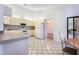 Bright kitchen with tile floors and white cabinets and appliances with eat-in space at 8522 Cranes Roost Dr, New Port Richey, FL 34654