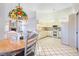 Eat-in kitchen with white cabinets, appliances, and view to the Gathering room with fireplace at 8522 Cranes Roost Dr, New Port Richey, FL 34654