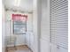 Laundry room featuring white appliances and cabinets with a window with blinds at 8522 Cranes Roost Dr, New Port Richey, FL 34654