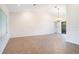 Spacious living room featuring neutral walls, tile flooring, and decorative light fixture at 8522 Cranes Roost Dr, New Port Richey, FL 34654