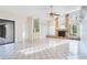 Spacious living room with a stone fireplace, tiled floors, and a built-in wet bar at 8522 Cranes Roost Dr, New Port Richey, FL 34654