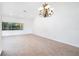 Spacious living room with tile flooring, large window view and decorative light fixture at 8522 Cranes Roost Dr, New Port Richey, FL 34654
