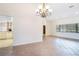 Bright living room area with tile floors adjacent to a kitchen with white appliances at 8522 Cranes Roost Dr, New Port Richey, FL 34654