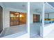 Covered patio overlooking the lake with tile flooring and access to other rooms at 8522 Cranes Roost Dr, New Port Richey, FL 34654
