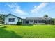 Backyard view of a pool enclosed within a screened lanai, surrounded by landscaping at 8522 Cranes Roost Dr, New Port Richey, FL 34654