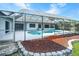 Backyard with a screened-in kidney shaped pool, stone accents and large sun deck at 8522 Cranes Roost Dr, New Port Richey, FL 34654
