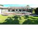 Enclosed kidney shaped pool with a large sun deck, and a manicured lawn at 8522 Cranes Roost Dr, New Port Richey, FL 34654