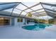 Screened-in pool and deck area with a view of the lake and surrounding greenery at 8522 Cranes Roost Dr, New Port Richey, FL 34654