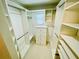 Organized walk-in closet with custom shelving, drawers, and ample storage space at 8522 Cranes Roost Dr, New Port Richey, FL 34654