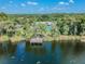 Aerial view of the lakefront community with pool, dock, and lush landscape at 9309 Edistro Pl, New Port Richey, FL 34654