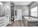 Relaxing bathroom with soaking tub and vanity with double sinks at 9309 Edistro Pl, New Port Richey, FL 34654