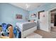Bedroom with light blue walls, carpet, and queen sized platform bed with storage drawers at 9309 Edistro Pl, New Port Richey, FL 34654