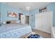 Bedroom with light blue walls, carpet, and queen sized platform bed with storage drawers at 9309 Edistro Pl, New Port Richey, FL 34654