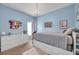 Bedroom with light blue walls, carpet, and queen sized platform bed with storage drawers at 9309 Edistro Pl, New Port Richey, FL 34654