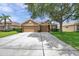 Attractive single-Gathering home featuring a three-car garage, well-kept lawn, and a welcoming entrance at 9309 Edistro Pl, New Port Richey, FL 34654