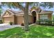 Inviting single-Gathering home with a three-car garage, a well-manicured lawn and mature trees at 9309 Edistro Pl, New Port Richey, FL 34654