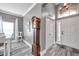 Elegant foyer with high ceilings, wood-look flooring, an antique clock and a front door at 9309 Edistro Pl, New Port Richey, FL 34654
