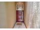 Welcoming front door with decorative details and a 'hello' doormat in a stucco entryway at 9309 Edistro Pl, New Port Richey, FL 34654