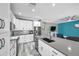 Open kitchen with a large island, stainless steel appliances, and modern finishes at 9309 Edistro Pl, New Port Richey, FL 34654