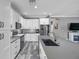 Bright kitchen featuring an island, stainless steel appliances, and modern design at 9309 Edistro Pl, New Port Richey, FL 34654