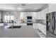 Bright kitchen with white cabinets, stainless steel appliances, and center island with sink at 9309 Edistro Pl, New Port Richey, FL 34654